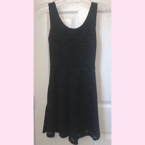 Little lace black dress with open, tied backing